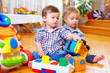 © Olesia Bilkei - two cute baby toddlers playing in nursery room