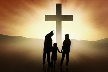 Christian family standing at the Cross