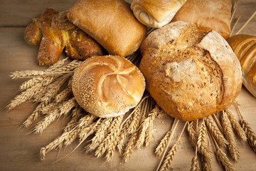 Wall Mural - assortment of fresh baked bread on wood table