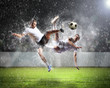 © Sergey Nivens - two football players striking the ball