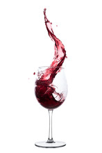Red Wine Splashing Out Of A Glass, Isolated On White