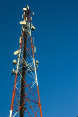 Communication tower on blue sky background