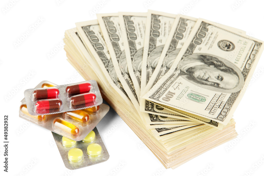 Pills and money isolated on white