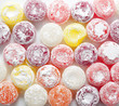 Sweet colorful candies lollipops in powdered sugar.
