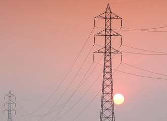 Electricity transmission pylon  in the field on sunset