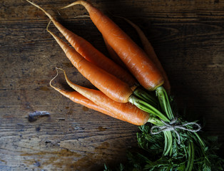 Wall Mural - bundle of carrots on wooden background