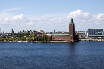 Old city skyline on blue water under blue sky