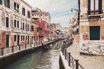  Typical canal with gondola. Venice, Italy.