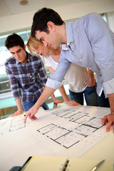 Startup business team working on blueprint