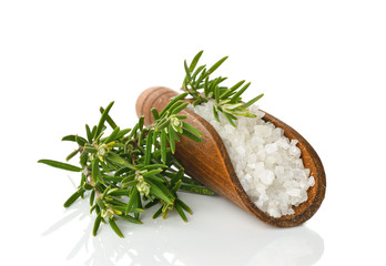 Canvas Print - Salt in a wooden scoop and rosemary on a white background