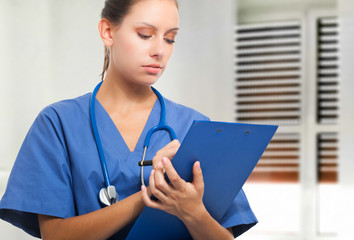 Poster - Nurse writing on a clipboard