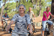 old woman and three other people doing bike in the forest