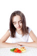 © Natalya Antoshchenko - Young woman looks at a plate of salad diet