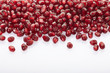 Pomegranate seed border on white background, body care