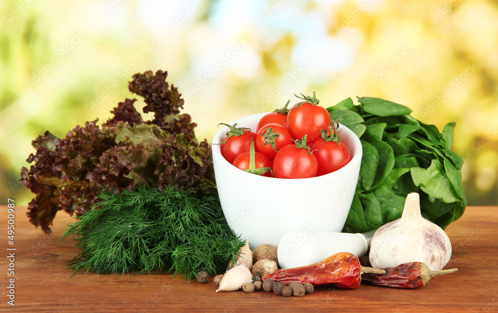 Composition of mortar, spices, tomatoes and  green herbs,