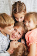 © Vitalinka - Four children kissing mother. Family concept