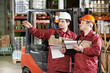© Kadmy - warehouse workers in front of forklift