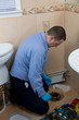 © Globalphotogroup - Plumber fixing toilet