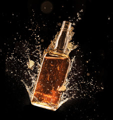 Wall Mural - Concept of liquor splashing around bottle on black background