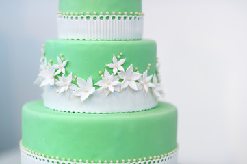 Wall Mural - Green wedding cake decorated with white flowers