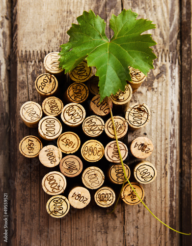 Fototapeta na wymiar Dated wine bottle corks on the wooden background