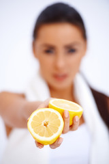 Wall Mural - Close up of a woman showing fresh lemon