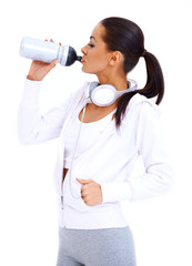 Wall Mural - Sporty woman drinks from fitness bottle