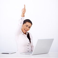 Wall Mural - Happy woman sitting at her desk, with one arm rised