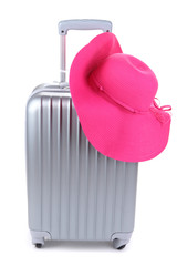 Silver suitcase with woman's hat  isolated on white