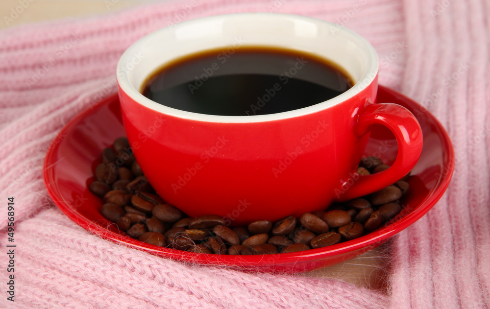 cup of coffee with scarf on table in room