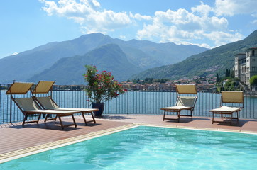 Wall Mural - Row of sunbeds against Como lake, Italy