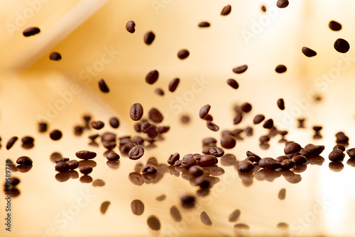 Naklejka na szybę Flying coffee beans on a abstract background