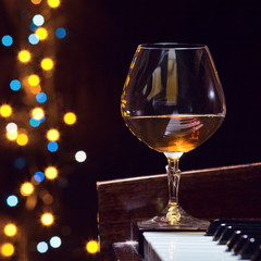 Wall Mural - snifter with brandy on a piano