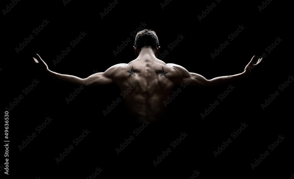 Rear view of healthy young man with arms stretched out - obrazy, fototapety, plakaty 