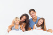 © WavebreakmediaMicro - Happy family posing on the bed
