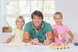© WavebreakmediaMicro - Smiling family with baking tools
