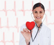 © WavebreakmediaMicro - Doctor holding stethoscope up to red heart graphic