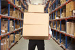 © Monkey Business - Man Carrying Boxes In Warehouse