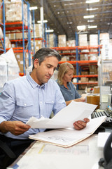 Wall Mural - Business Colleagues Working At Desk In Warehouse