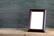 © Anatoliy Sadovskiy - Old photo frame on wooden table