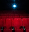 © Nejron Photo - Empty comfortable red seats with numbers in cinema