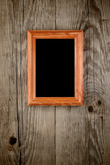 Photo frame on old wooden background