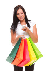 portrait cute young woman mobile phone while holding shopping ba