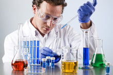 Chemist Working At A Lab Bench With Various Solutions