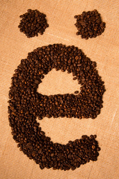 e, Alphabet from coffee beans on white background.