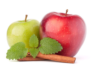 Red and green apples, cinnamon sticks and mint leaves still life