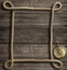 Wall Mural - aged rope frame and old brass compass