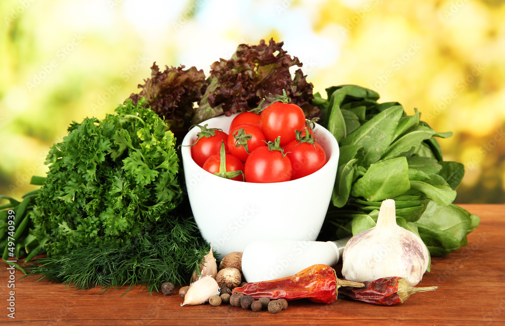 Composition of mortar, spices, tomatoes and  green herbs,