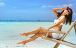© Alena Yakusheva - young beautiful woman relaxing on sand beach