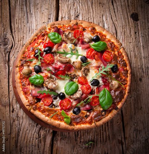 Fototapeta na wymiar Delicious italian pizza served on wooden table